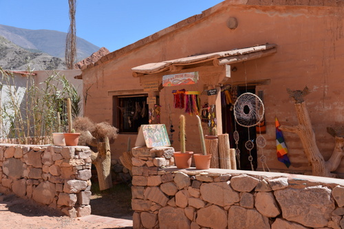 The first building is a shop which uses local building materials.