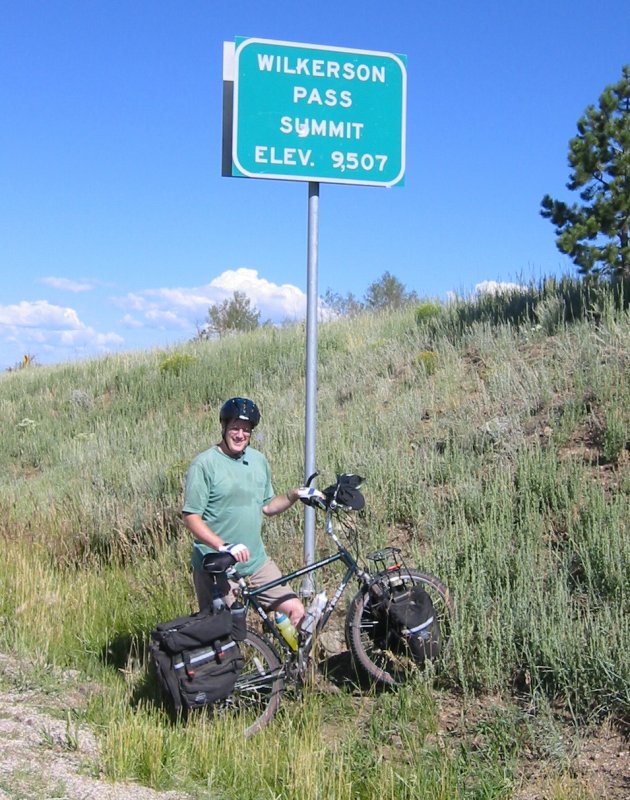 Dennis, holding up the summit sign.