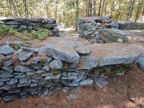 Man made stone laid ground structure.