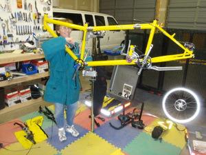 Assembling a bike at a bike stand.